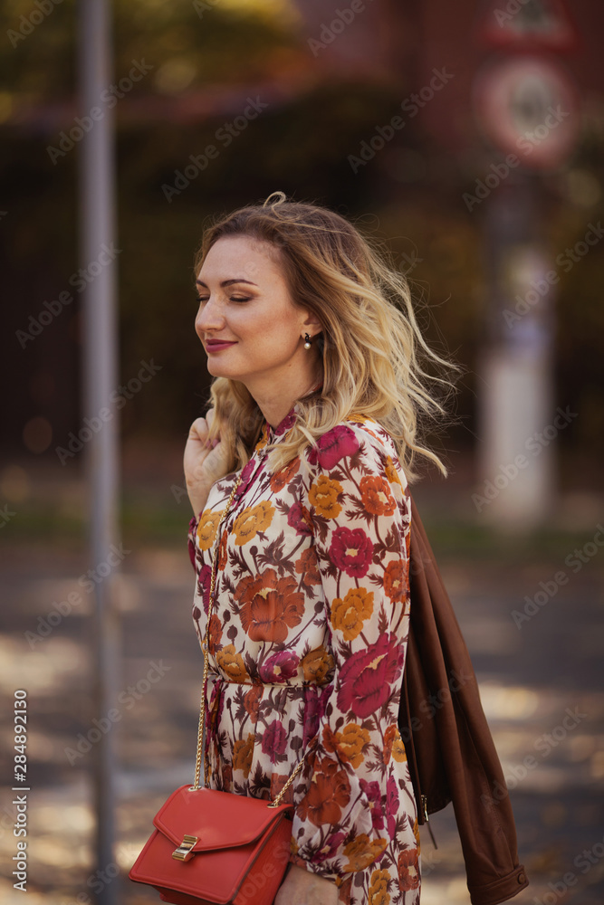 Beautiful woman walking in the autumn street Beautiful woman walking in the autumn street