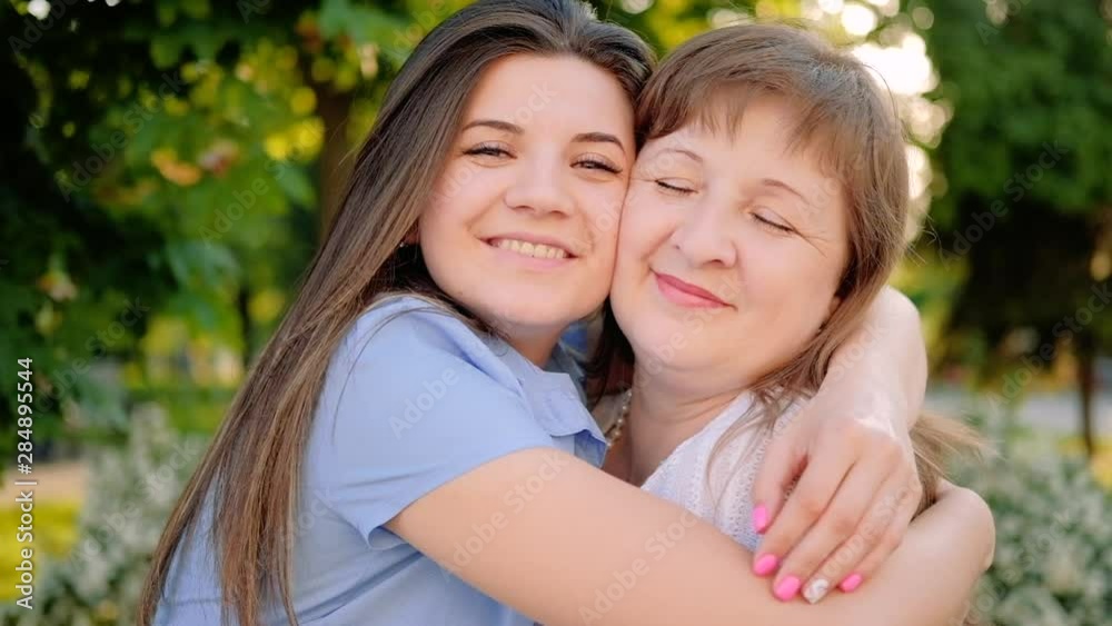 Mother day. Warm greeting. Loving daughter hugging mom smiling enjoying time. Mother day. Warm greeting. Loving daughter hugging mom smiling enjoying time.