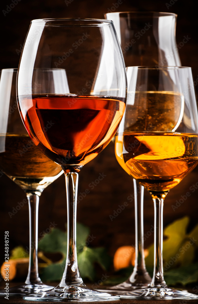 White wine set. Wine tasting, the most popular varieties of white wines in wine glasses on vintage wooden table in rustic style, selective focus