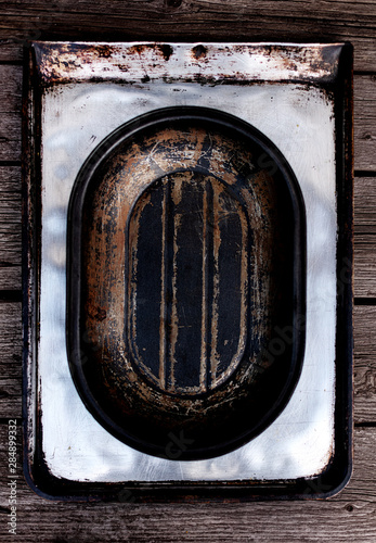 Old vintage baking pan and tins on wooden background.