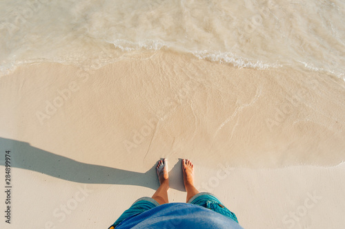 view of sandy beach with waves and clear ocean water. photo