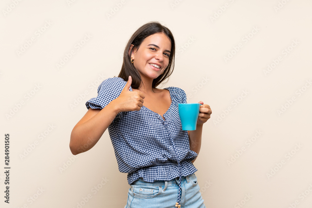 Young girl over isolated background holding hot cup of coffee Young girl over isolated background holding hot cup of coffee