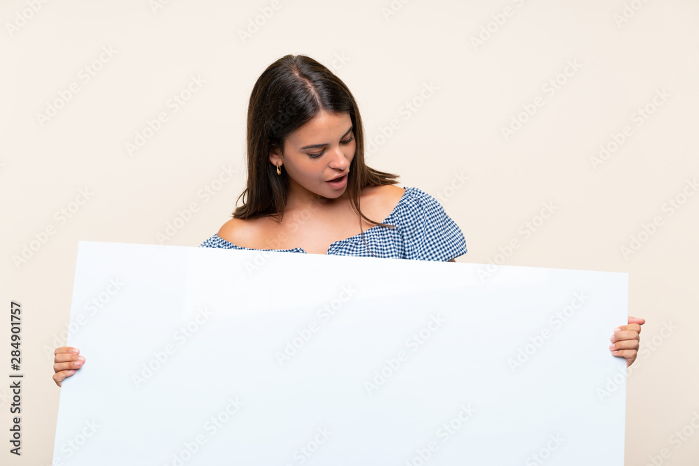 Young girl over isolated background holding an empty white placard for insert a concept Young girl over isolated background holding an empty white placard for insert a concept