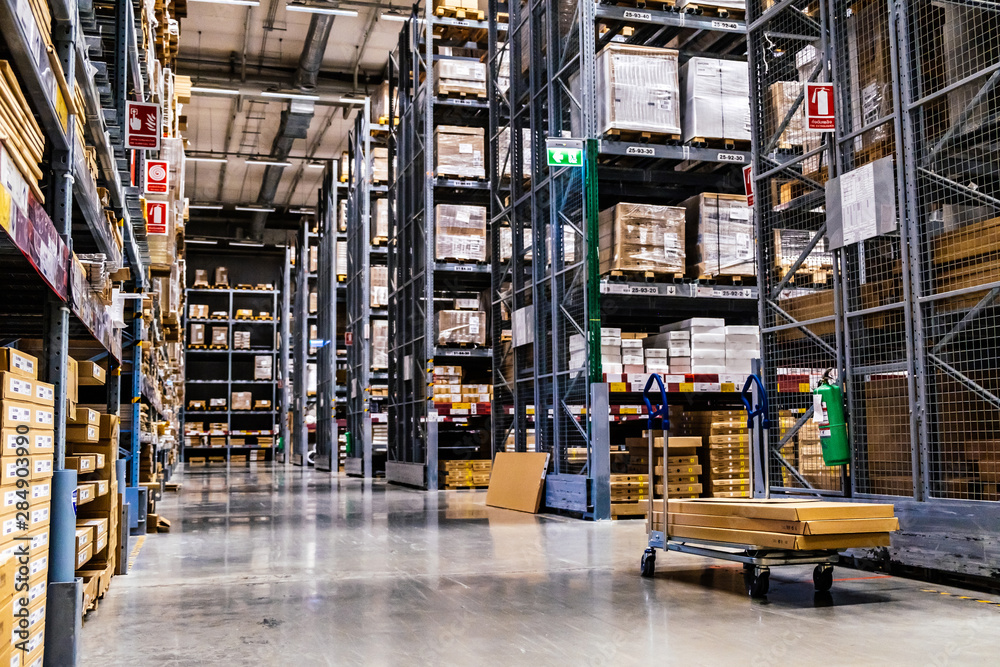 A cart in warehouse aisle in an IKEA store A cart in warehouse aisle in an IKEA store