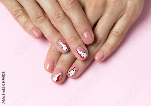 Bright fashionable abstract manicure on female hands.