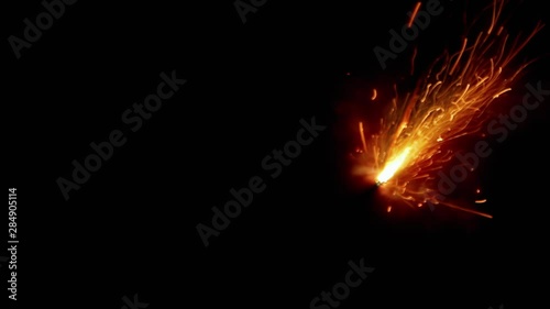 A burning fuse or slow match (used to ignite bengal fires) following a curved path. photo