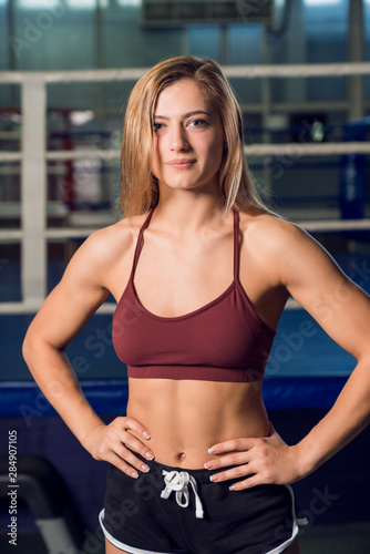 Young strong woman standing in front of boxing ring © Artur Ismailov