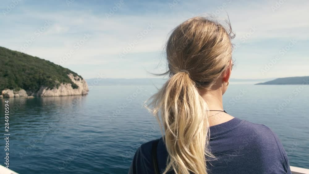 Woman looking on the ocean from ferry, islands, sunny day Woman looking on the ocean from ferry, islands, sunny day