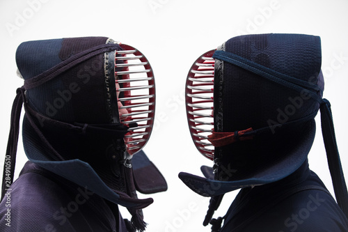 Portrait of man kendo fighter with shinai bamboo sword . Shot in studio. Isolated with clipping path on white background. photo