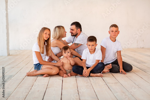 Big happy family with four kids indoors