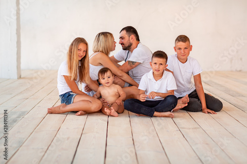 Big happy family with four kids indoors