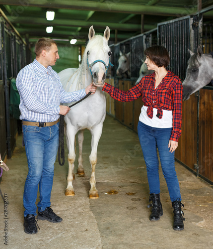 Portrait of couple standing at stable