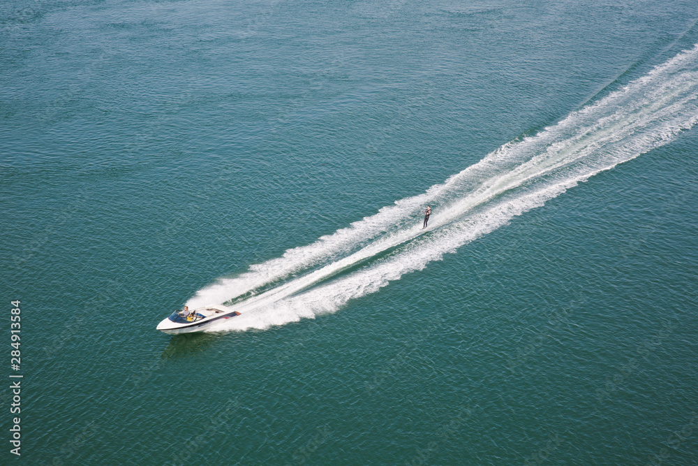 Speedboat with water skier Speedboat with water skier
