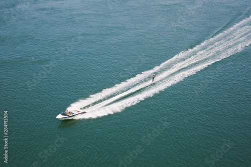 Speedboat with water skier © CarolAnne