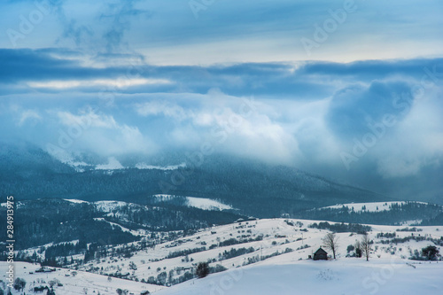 winter landscape. all covered with snow, mountains on horizon