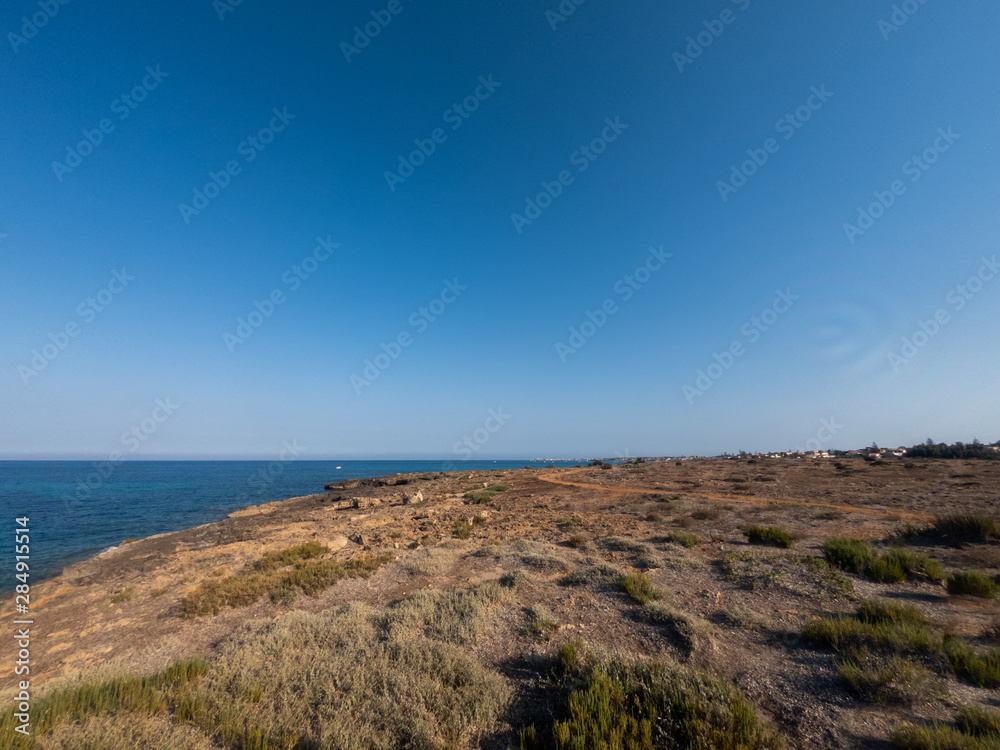 View of the beautiful San Lorenzo rock beach, in the southern Sicily, Italy. The shot is taken during a sunny summer day