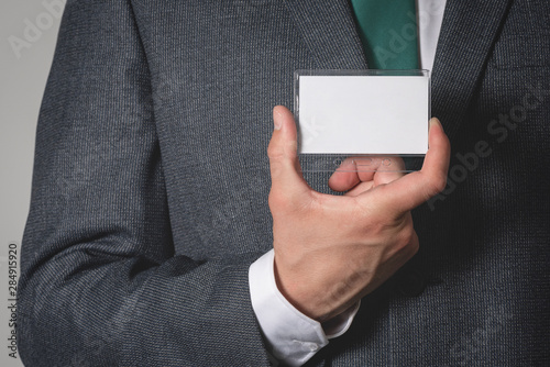 Blank name badge with a copy space in a businessman hands.