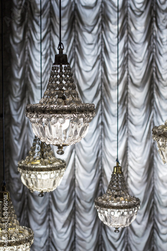 Crystal chandeliers on the background of curtains
