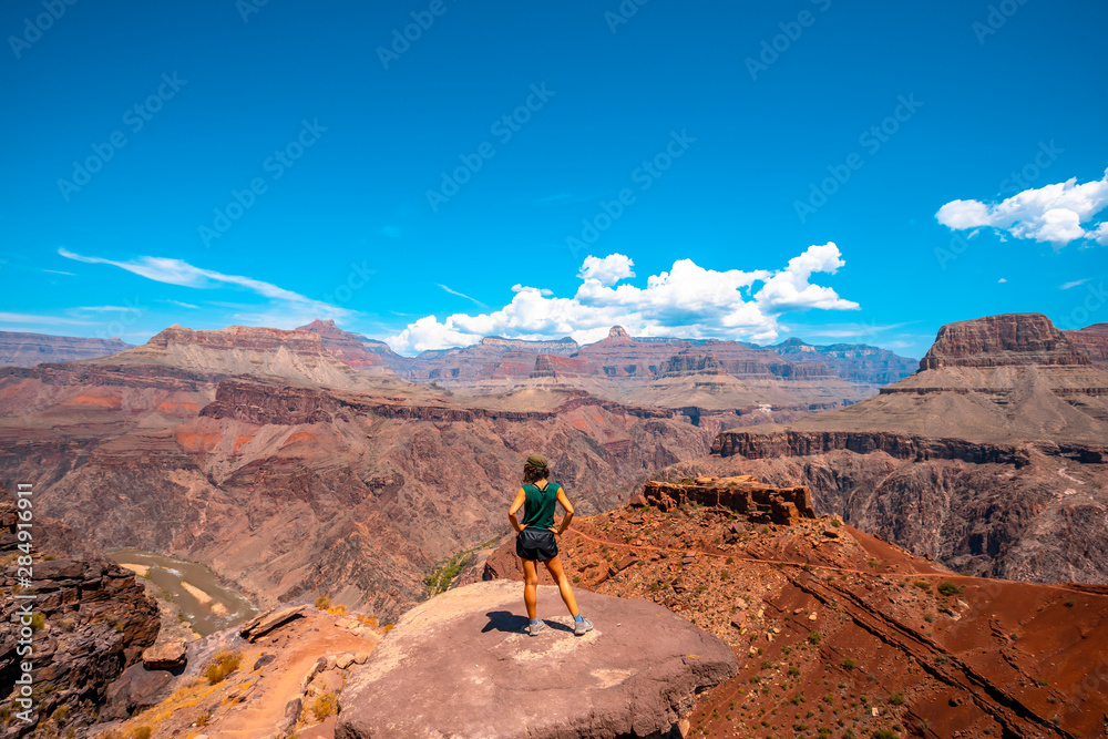 A young woman on a viewpoint of the South Kaibab Trailhead trekking. Grand Canyon