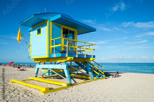 Bright scenic fine weather view of brightly painted lifeguard tower under sunny blue sky on South Beach, Miami, Florida