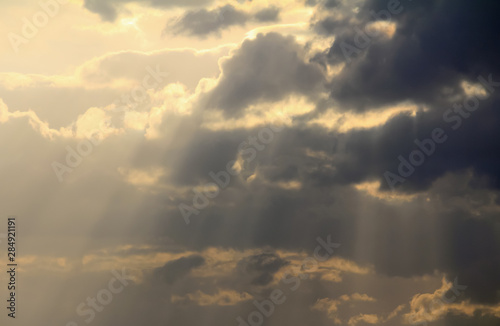 Spiritual Cloudscape Light rays streaking down across dark clouds like God's voice from heaven. © warren_price