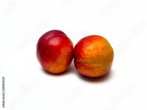 Two nectarines isolated on white background.