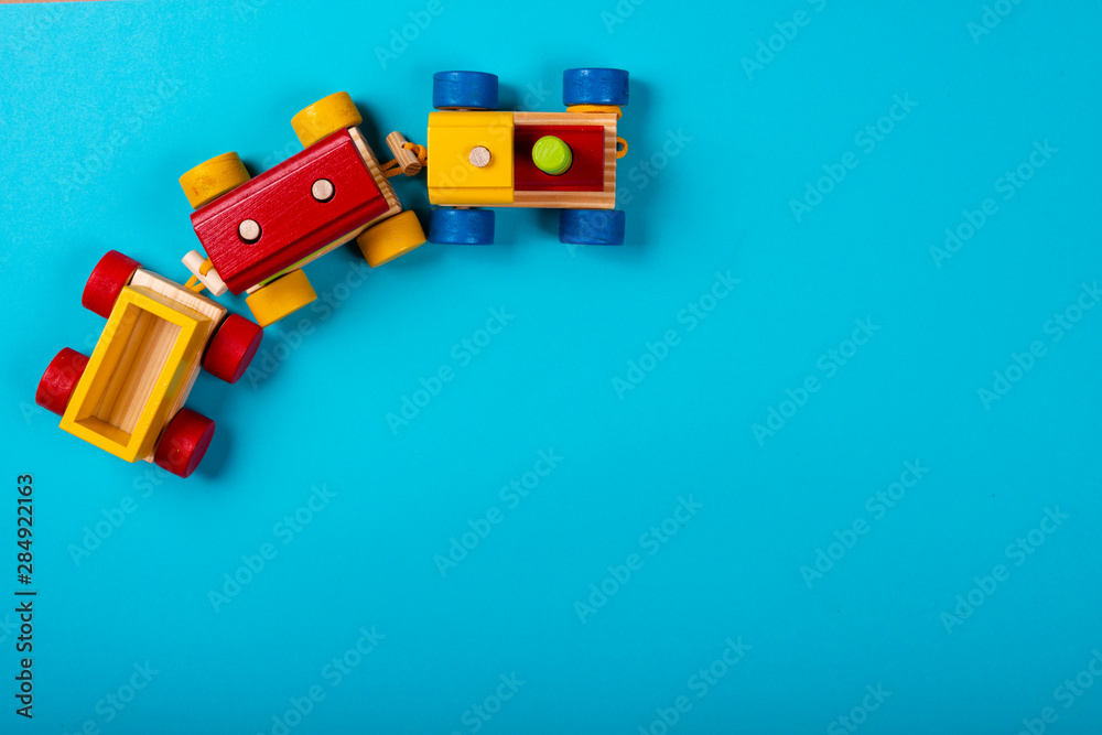 Wooden train on blue background with space for text. Wooden train on blue background with space for text.