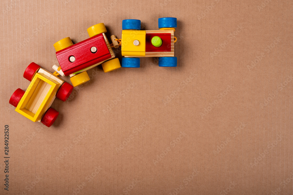 Obraz premium Wooden train on brown background with space for text.