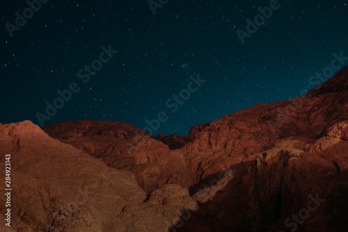 Night Astrophotography of the beautiful El Towaylat Mountain with the sky lit up by the stars in Dahab, South Sinai, Egypt in the middle of the Red Sea desert.