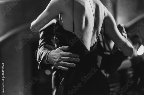 Canvas Print A man and a woman dancing tango. Black and white image