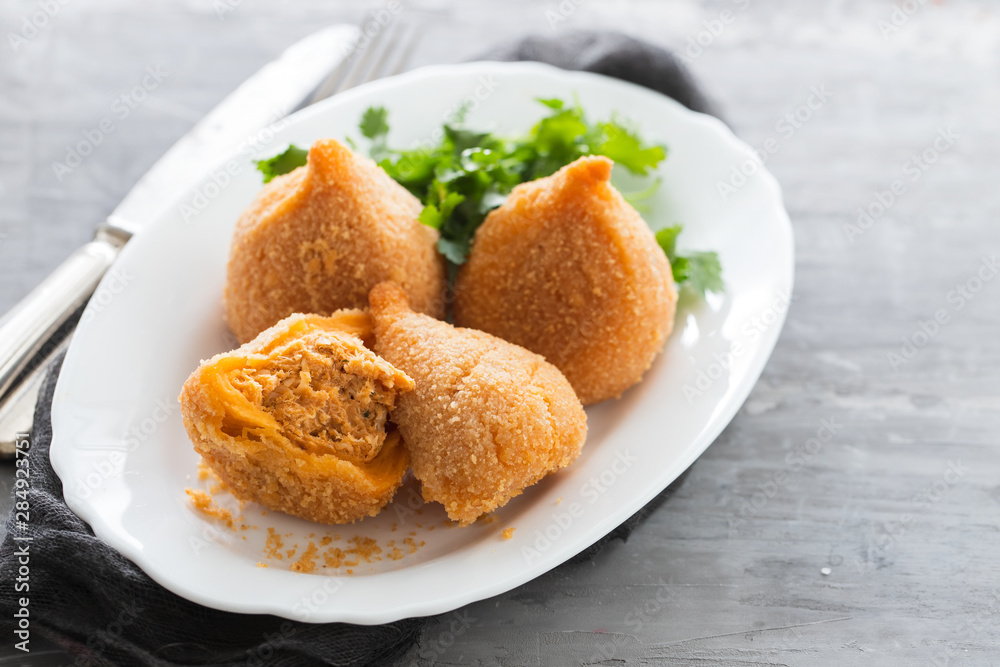 coxinha de frango, typical brazilian chicken croquette on white dish coxinha de frango, typical brazilian chicken croquette on white dish