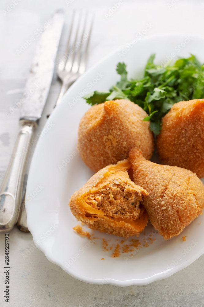 coxinha de frango, typical brazilian chicken croquette on white dish