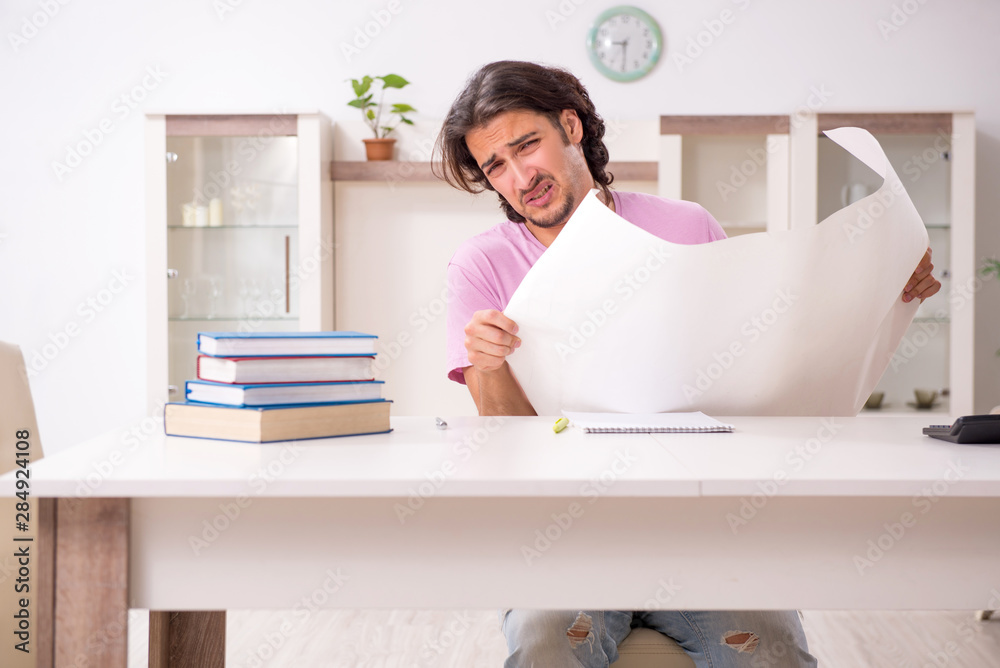 Young male architect student preparing for exams at home Young male architect student preparing for exams at home