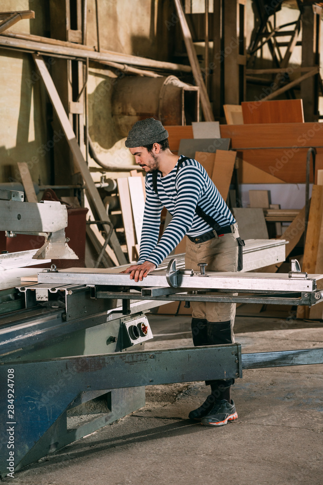 Carpenter working on a saw Carpenter working on a saw
