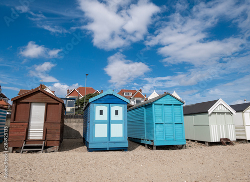 Traditional wooden huts houses on the beach against blue sky and clouds in Southend on asea © cristianbalate