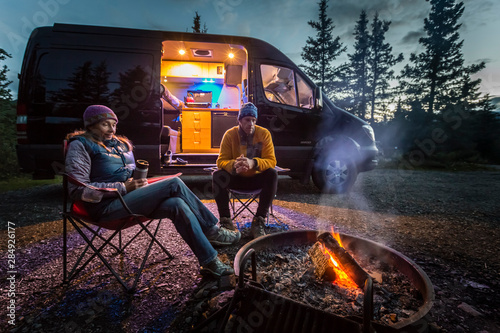 A couple by a fire in Teklanika Campground, Denali National Park, Alaska, USA photo