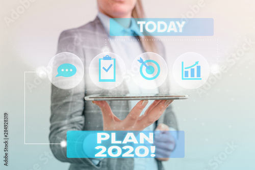 Writing note showing Plan 2020. Business concept for detailed proposal doing achieving something next year Female human wear formal work suit presenting smart device