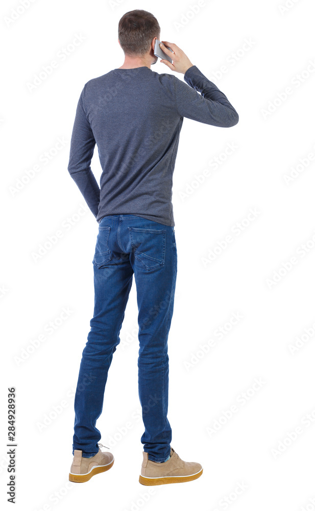 back view of a man talking on the phone back view of a man talking on the phone