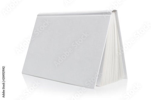 Fotografija Inverted blank white hard cover book, isolated on white background
