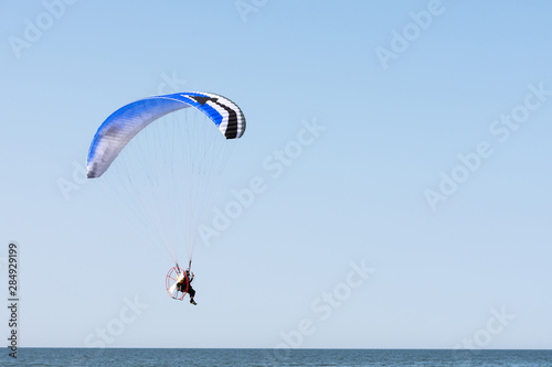 paragliding by the sea. sunny day