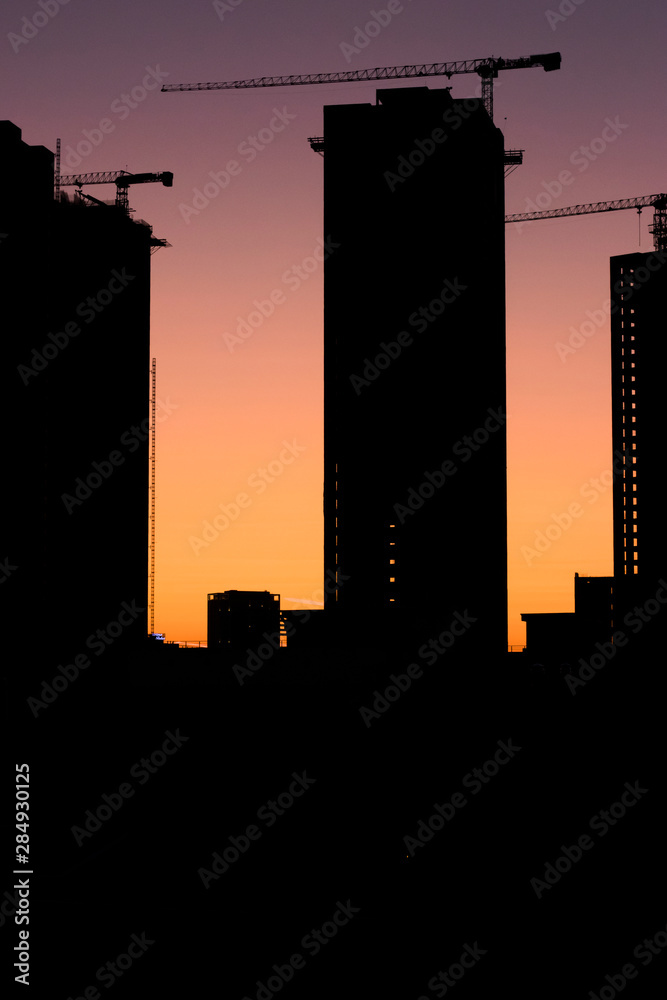 Silhouette construction industry building on high ground sepia style stock photo