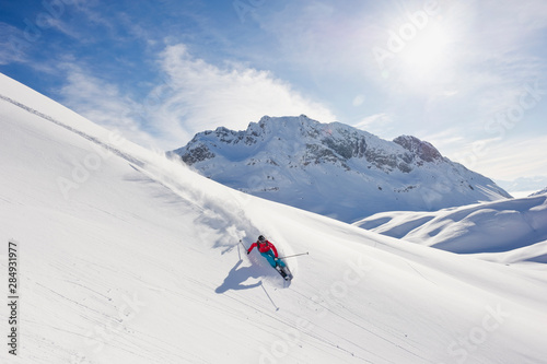 Austria, Zurs, Lech, Young woman doing alpine skiing on Arlberg mountain photo