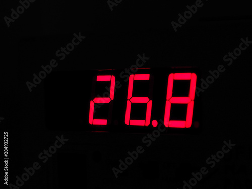 Digital LCD display of thermometer showing hot temperature in Ce