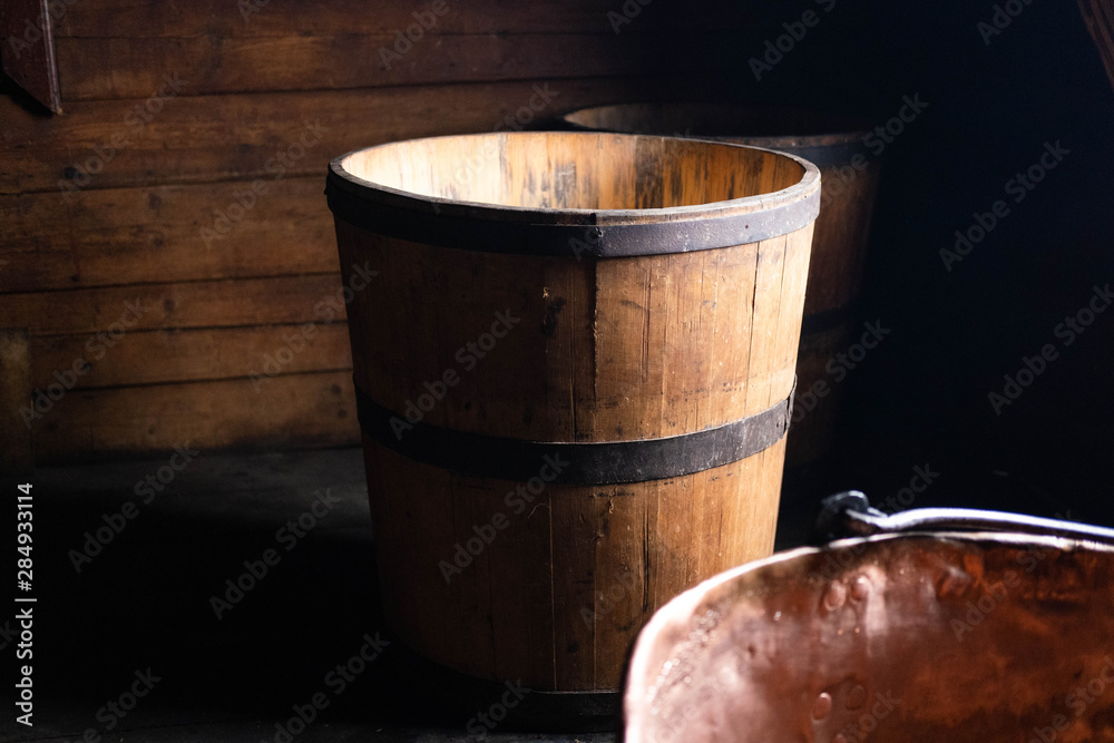 Wooden tub for milk, water. Kadka which is used in the traditional production of hard cheese in Ukraine. Traditional cheese making tools . Kadka which is used in the traditional production Wooden tub for milk, water. Kadka which is used in the traditional production of hard cheese in Ukraine. Traditional cheese making tools . Kadka which is used in the traditional production