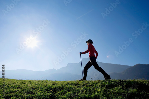 Woman exercising Nordic Walking, Austria, alps