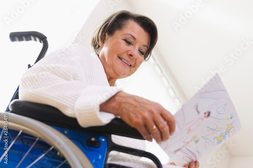 Germany, Leipzig, Senior woman sitting on wheelchair photo