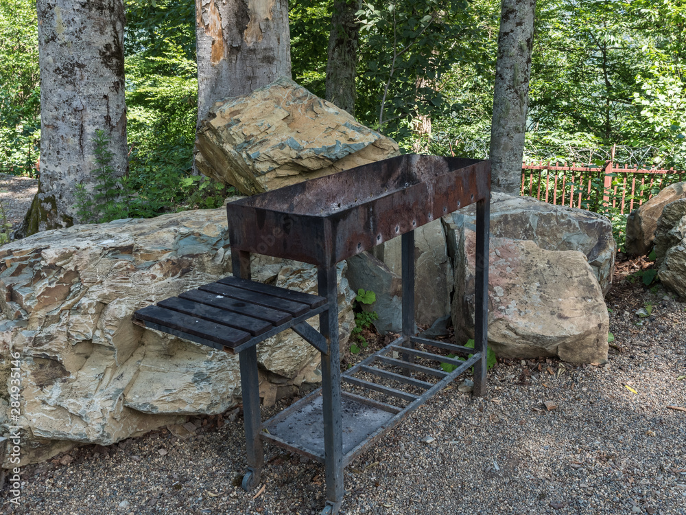 Barbecue on the background of large stones in forest Barbecue on the background of large stones in forest