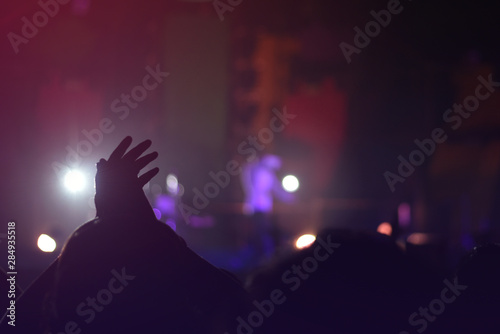 silhouettes of  , Fun concert party rock disco light background. © Siriwat