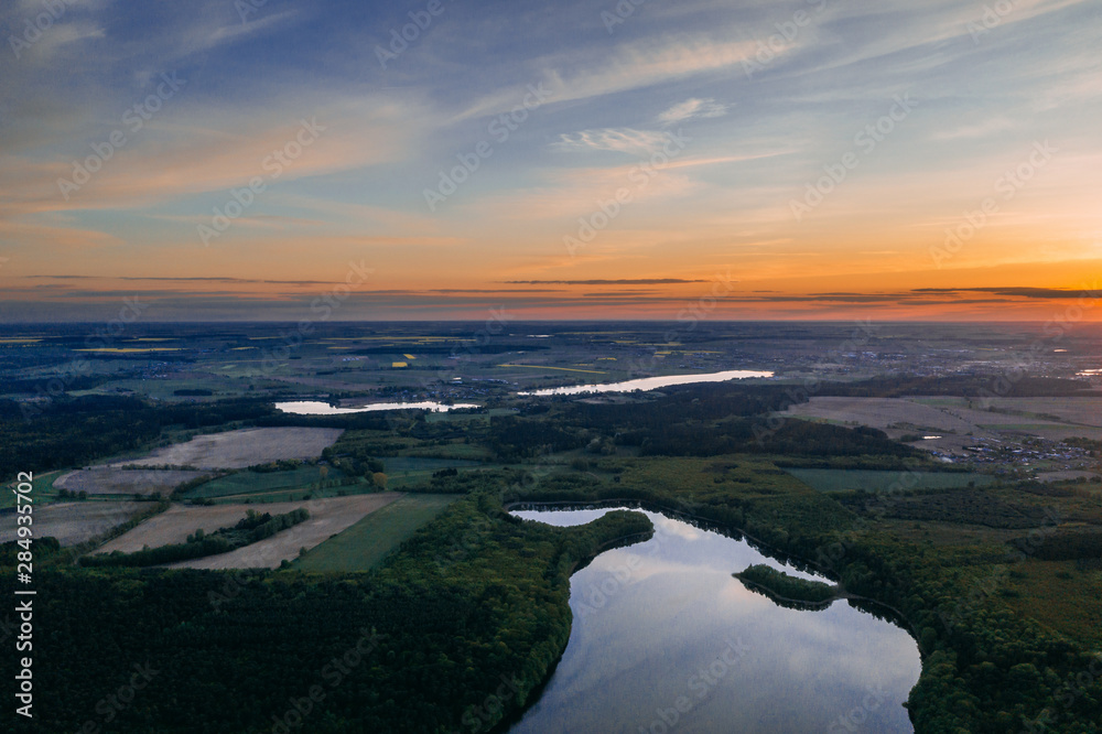Aerial drone photography of a lake landscape during sunset. Beautiful and calm rural landscape. 