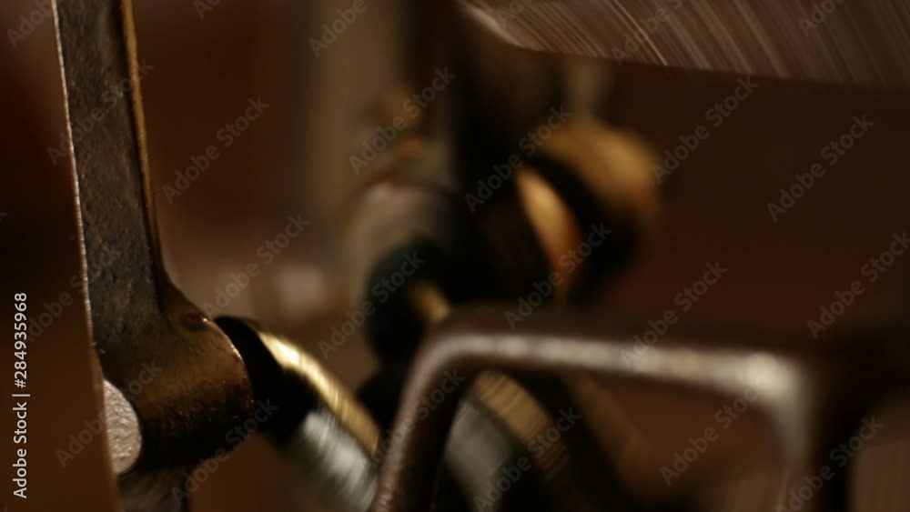 Old sewing machine close-up. Retro gear, belt drive, vintage wheels